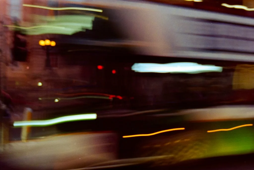 Abstract long-exposure photograph of dark motion blur and light streaks representing digital speed and data flow.